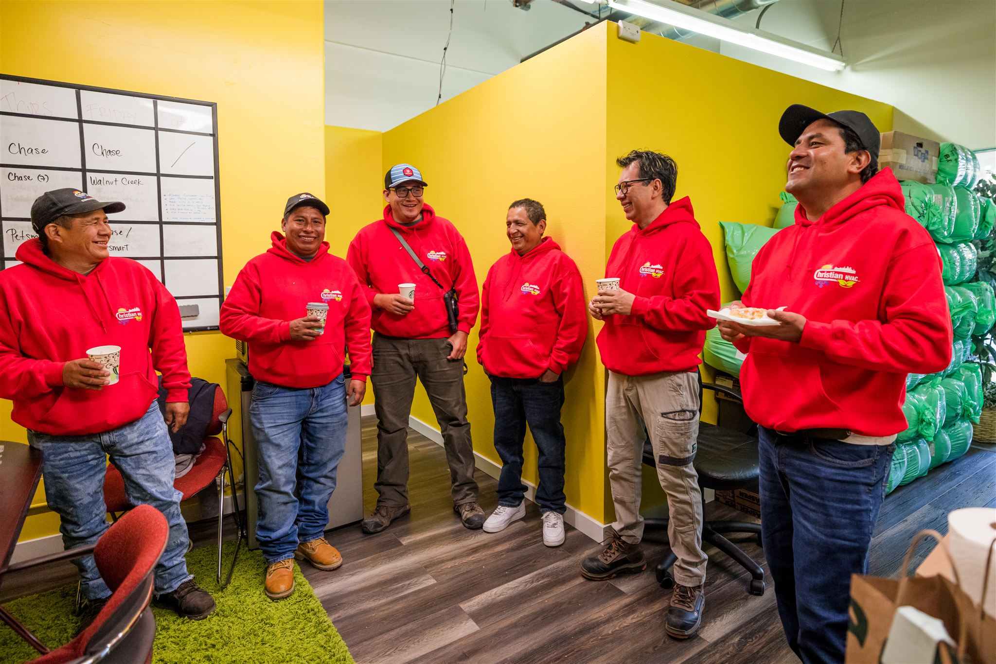 Christian HVAC team sharing a candid moment at the shop