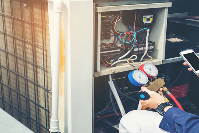 Technician checking HVAC equipment