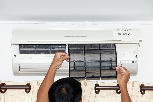 Technician checking an air filter