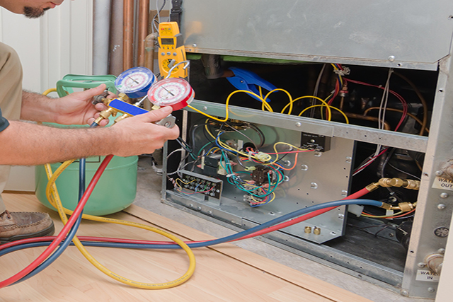 Technician charging an HVAC system